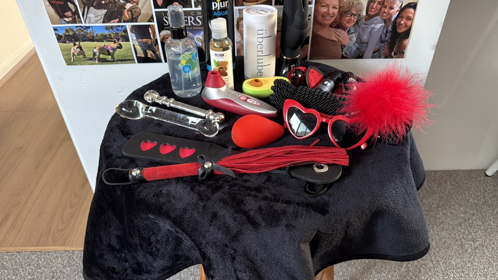 Table with a range of sex toys and pleasure enhancing items